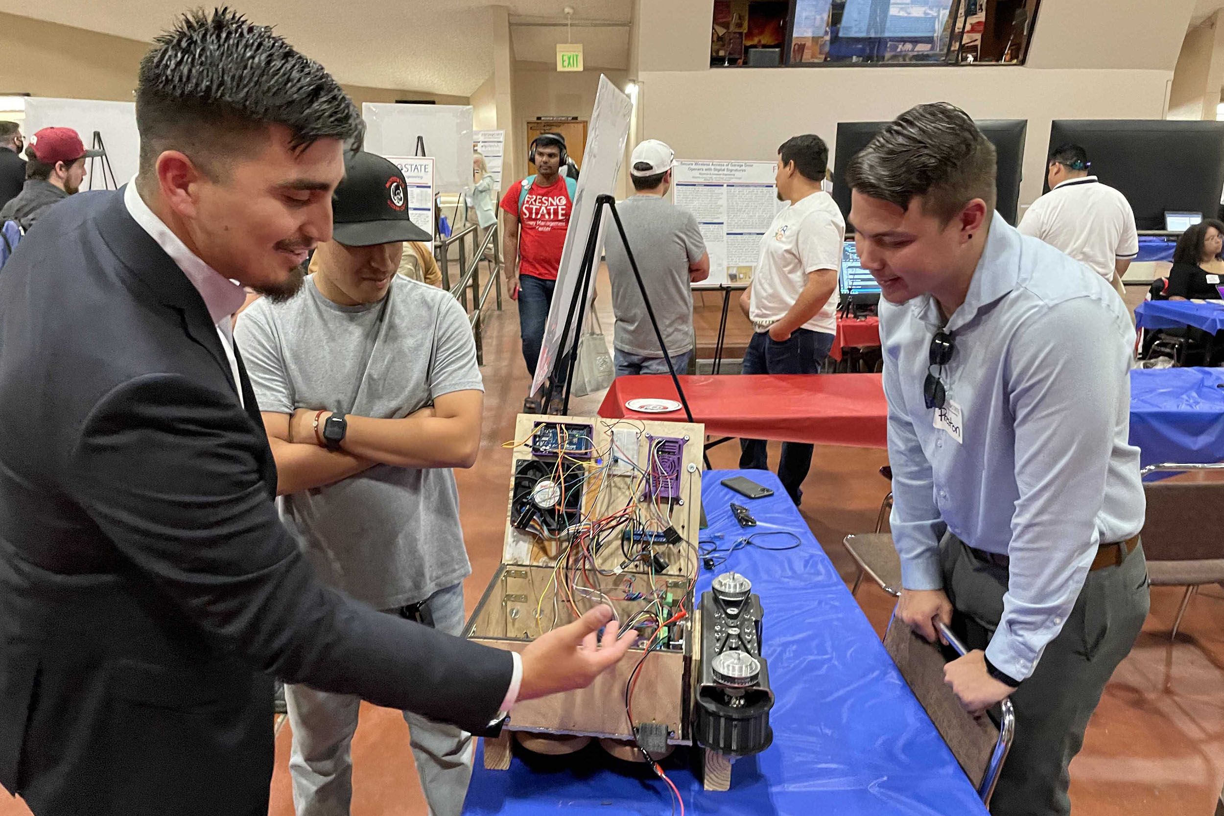 Students looking at wires on project