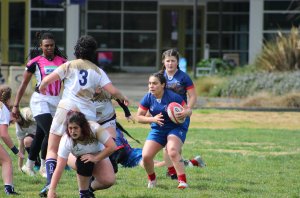 Mira Patino running the ball during a rugby game