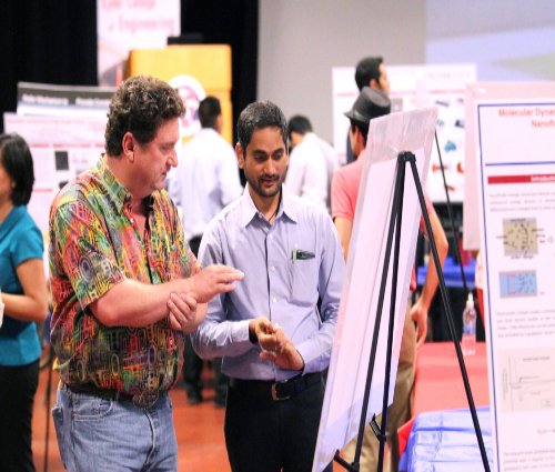 Engineering student presenting research poster board at Projects Day