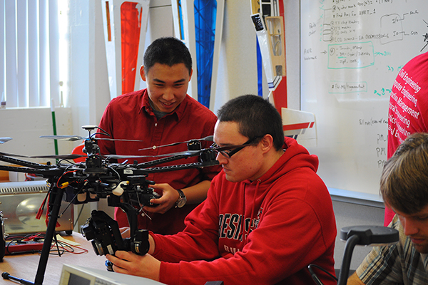 Students working on a Machine